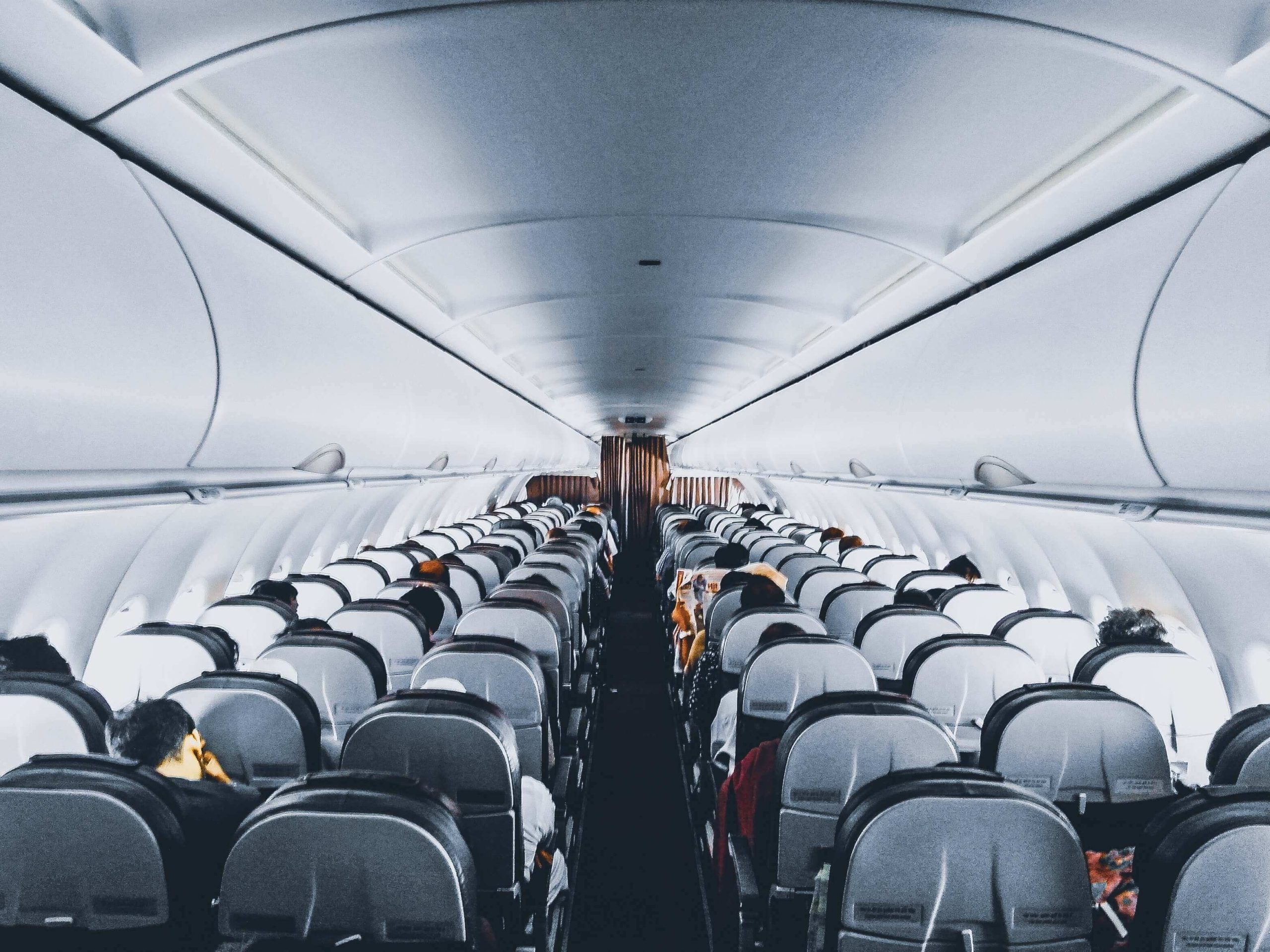 A plane wing and passengers getting on board