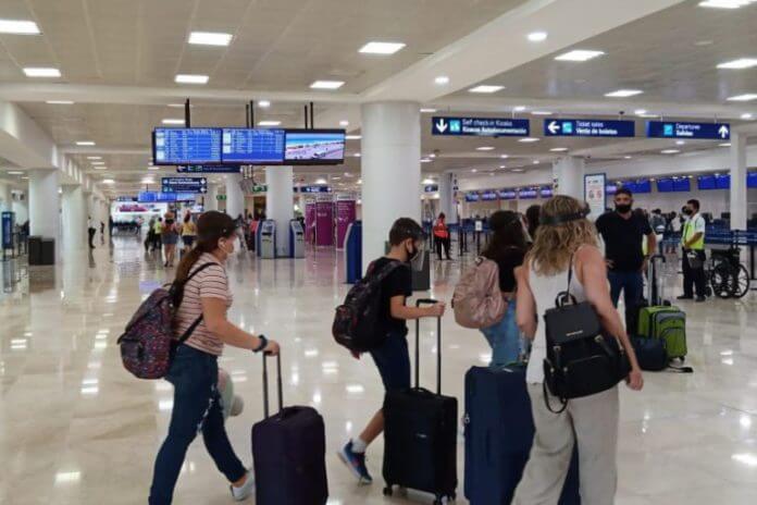 Tourists rushing into Cancun Airport for the holidays