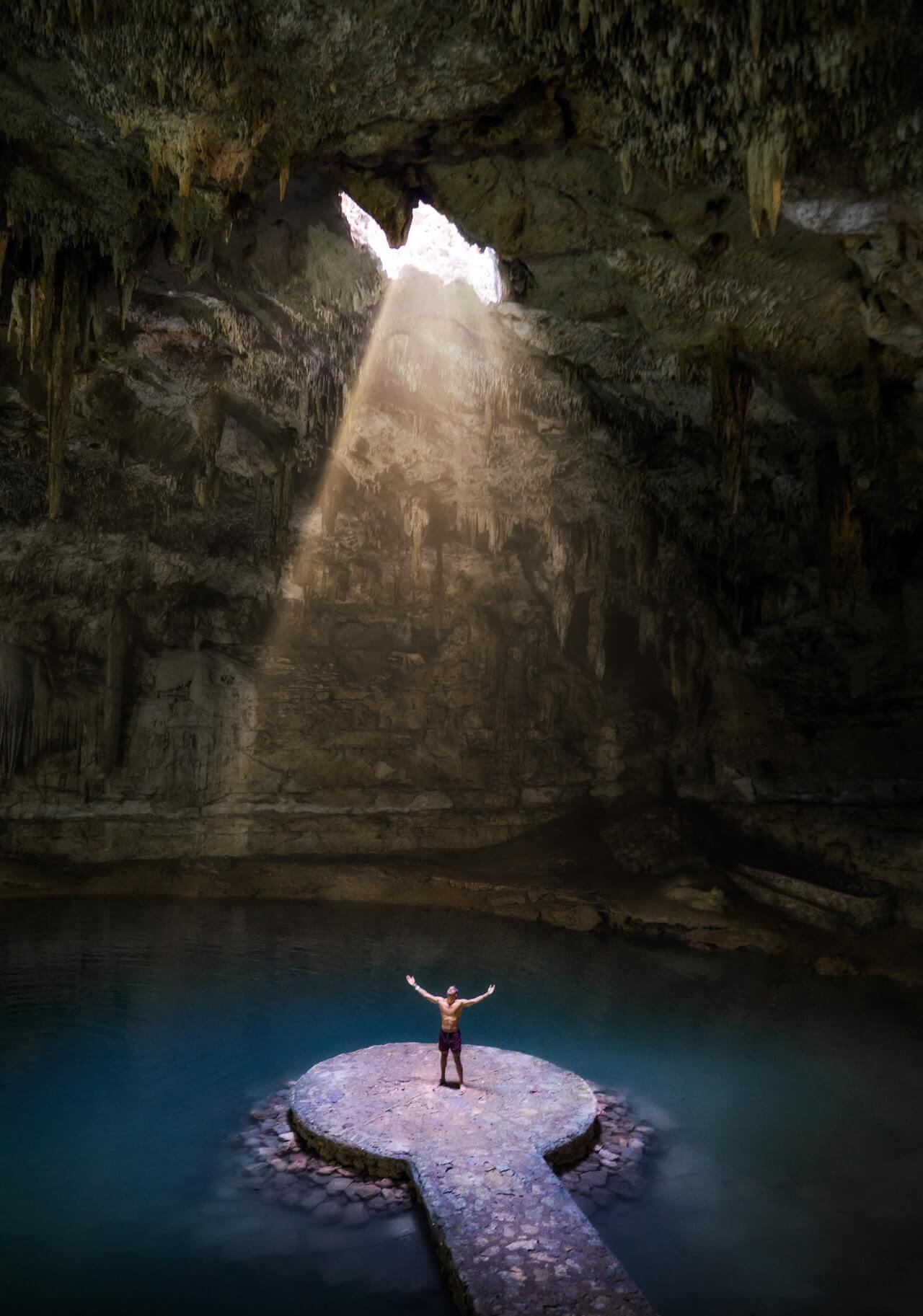 Man standing in Cenote Suytun