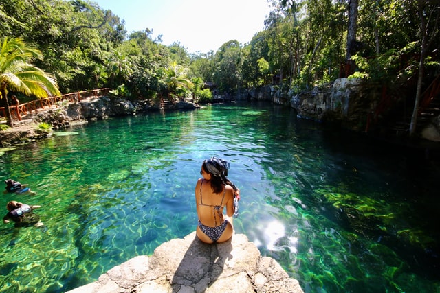 Woman on the edge of the water in the Riviera Maya.