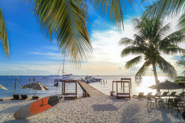 A sandy beach at Isla Mujeres with palm trees.