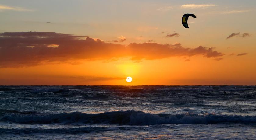 Sunset in Tulum with a parachute passing by