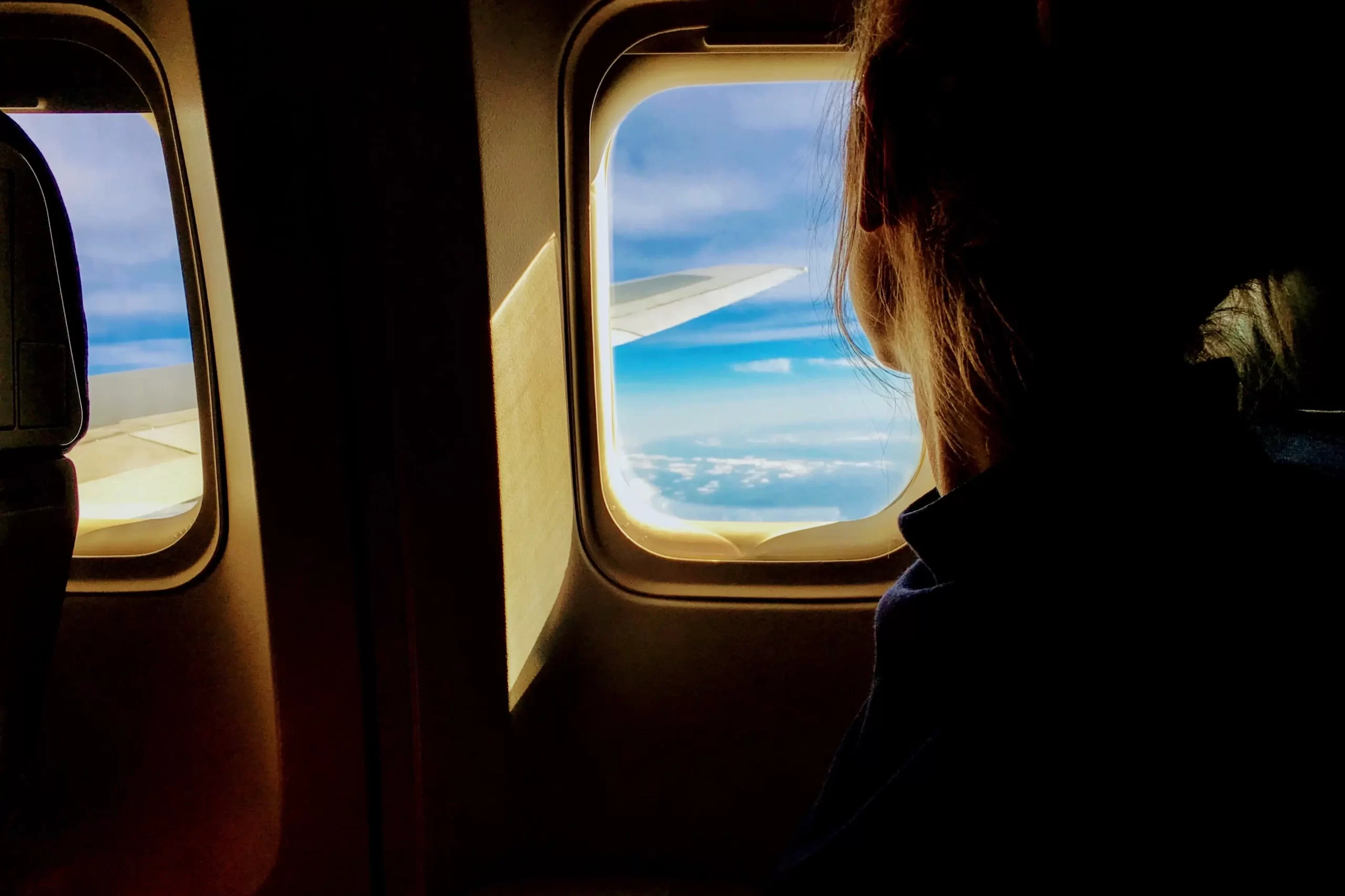Girl looking out of the plane window