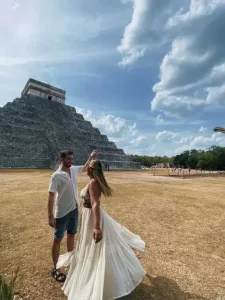 Couple dancing at Chichen Itza in front of the Pyramid of Kukulkan
