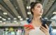 Traveler checking flight and terminal information before leaving Cancun Airport