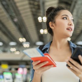 Traveler checking flight and terminal information before leaving Cancun Airport