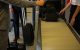 Airport staff assisting passengers with checked luggage on a conveyor belt